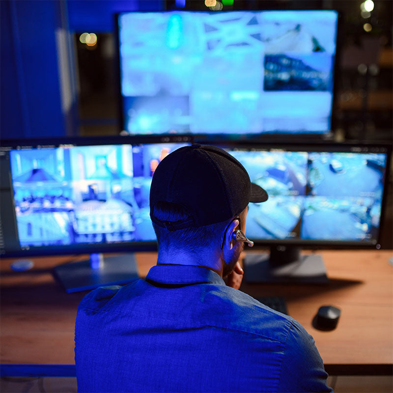 Man working at video surveillance computers.